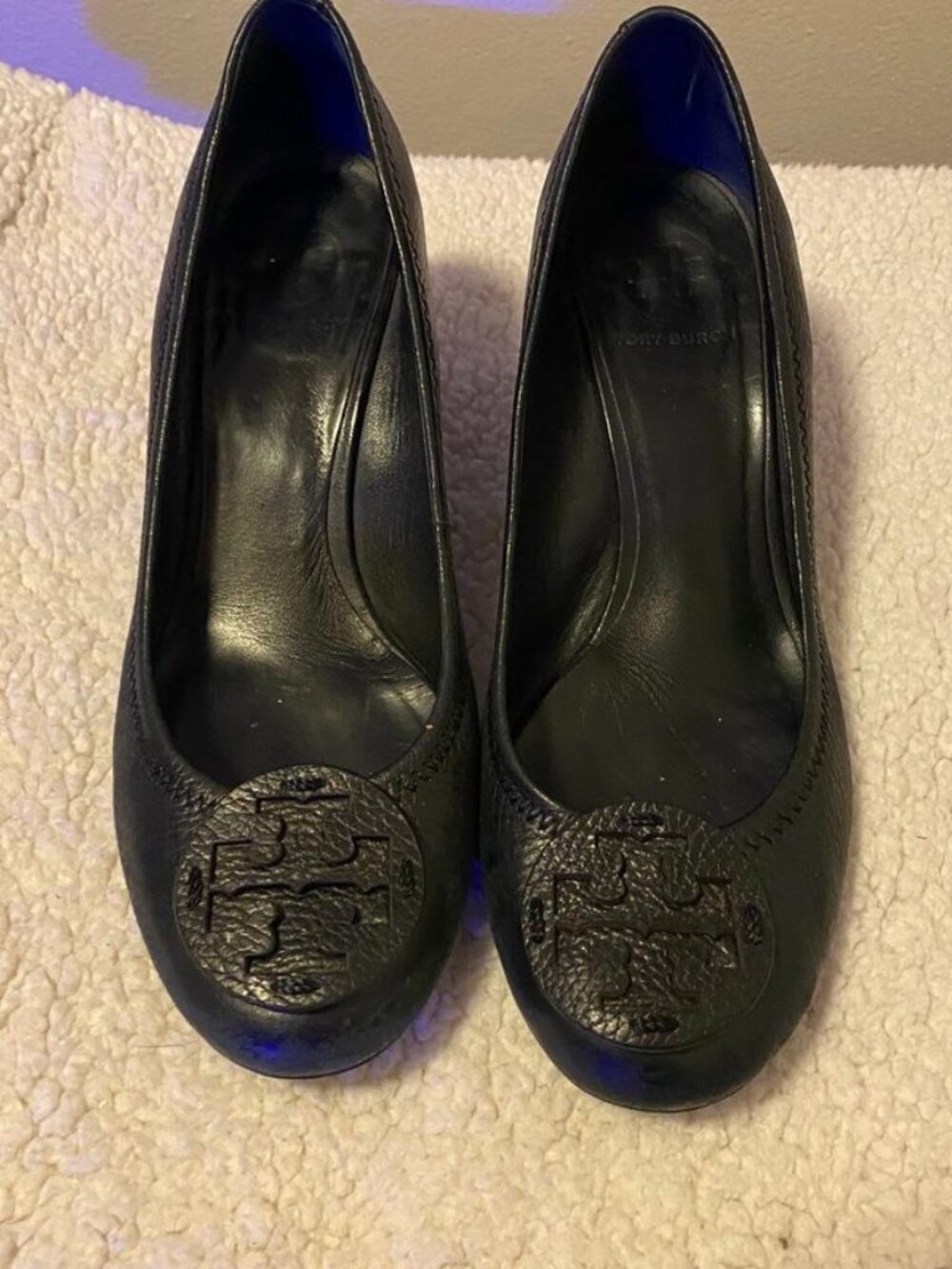 Tory Burch wedges are crafted from black pebbled leather